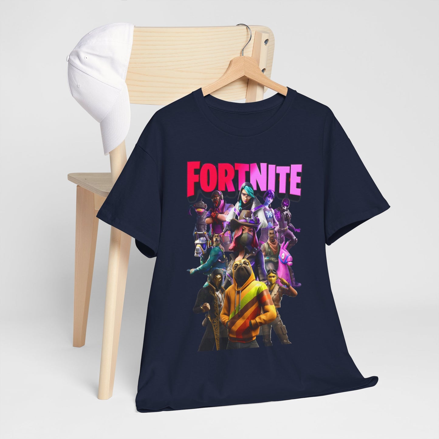 Chic Fortnite T-shirt draped over a wooden chair with a cap, highlighting vibrant gaming visuals for the ultimate casual outfit.