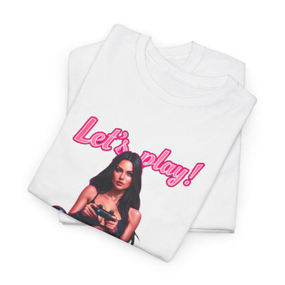Chic folded white t-shirt displaying a visually captivating 'Let's play!' design, showcasing a confident gamer, perfect for a playful wardrobe accent.