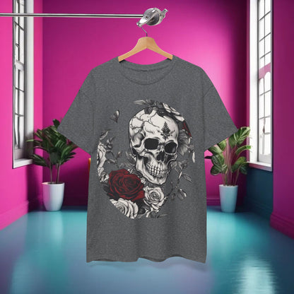 The Skulls and Roses Cotton Tee elegantly displayed on a hanger against a vibrant pink backdrop, showcasing its striking graphic design.