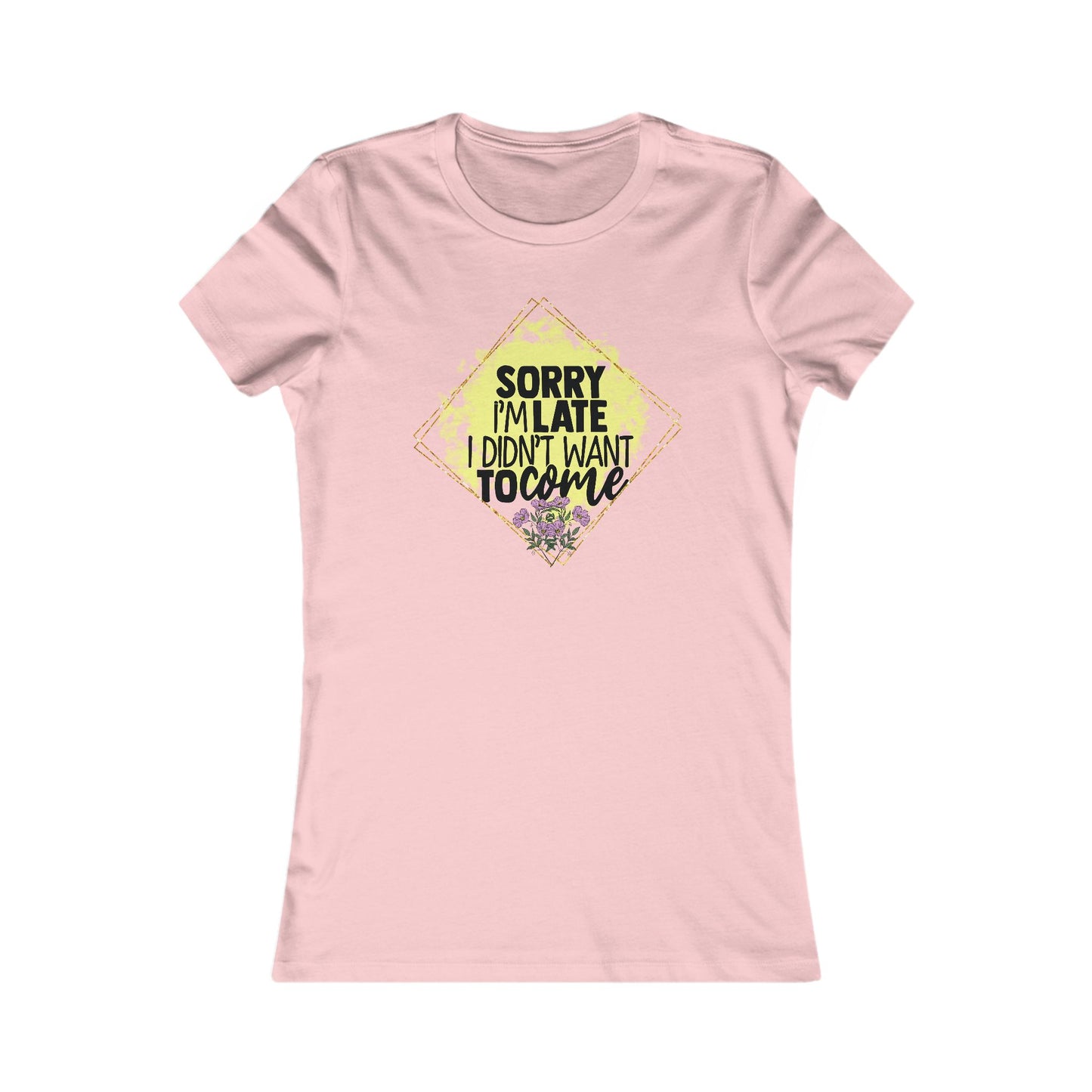 Chic women's pink t-shirt showcasing a stylish graphic design stating 'Sorry I'm Late, I Didn't Want to Come,' elegantly outlined in a diamond shape, embellished with yellow hues and floral details.