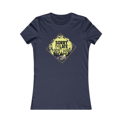 Elegant women's navy blue t-shirt featuring a bold graphic that reads 'Sorry I'm Late, I Didn't Want to Come,' framed by a luxurious diamond-shaped design with vibrant yellow watercolor effects and floral accents.