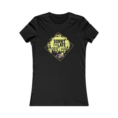 Chic black women's t-shirt showcasing a charming graphic design with the phrase 'Sorry I'm Late, I Didn't Want to Come', enhanced by elegant floral details and a sophisticated gold diamond border.