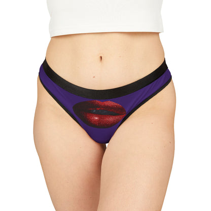 Sophisticated women's thong featuring a bold graphic of luscious red lips on a purple background, perfect for playful romantic occasions.