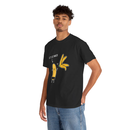 Male model wearing a luxury black t-shirt with a vibrant graphic of cheerful bananas and the phrase 'LET'S GET NAKED!', embodying modern urban elegance.