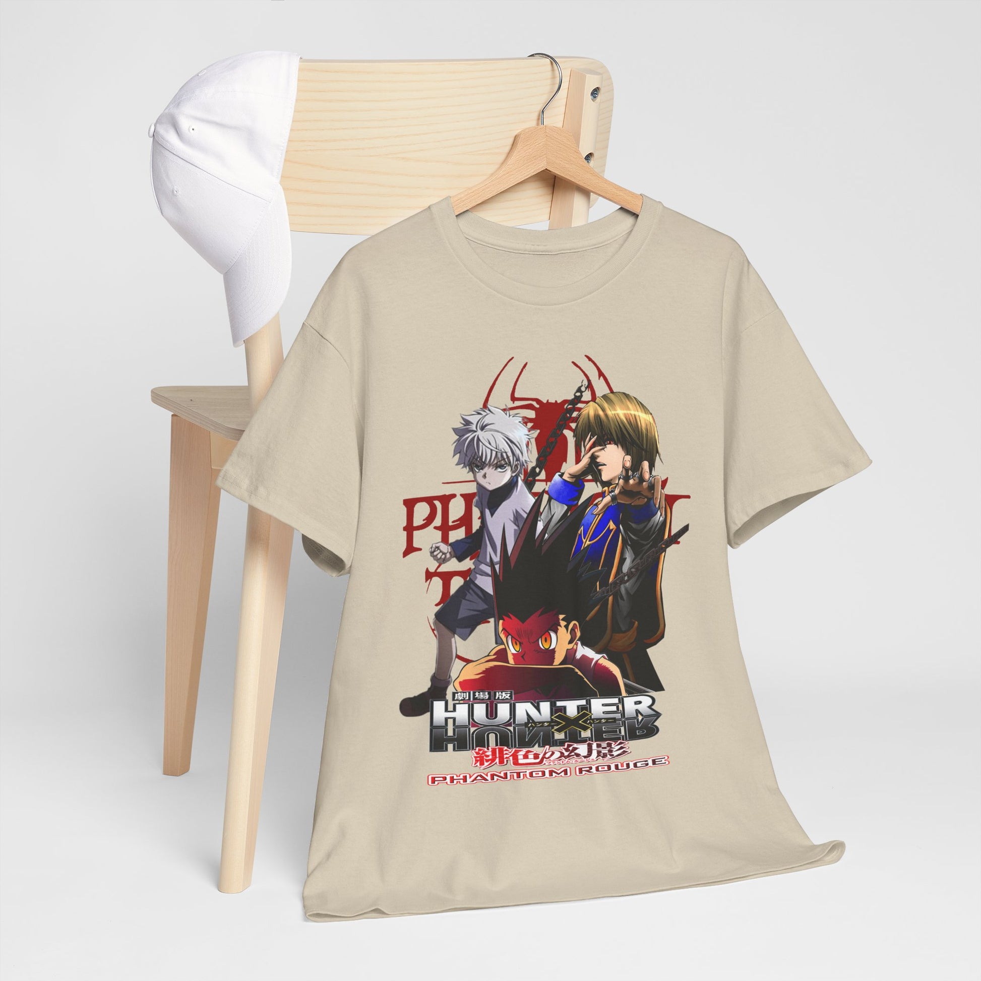 Stylish Hunter x Hunter T-shirt draped over a wooden chair, complemented by a white cap, showcasing a vibrant design of Phantom Rouge characters.