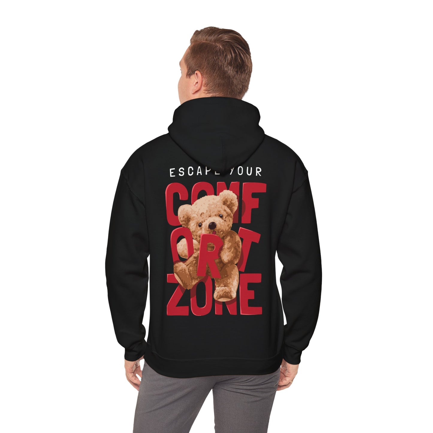Man dressed in a black hoodie with a captivating teddy bear design and inspiring message 'ESCAPE YOUR COMFORT ZONE' at the back, a blend of comfort and elegance.