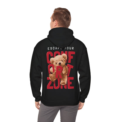 Man dressed in a black hoodie with a captivating teddy bear design and inspiring message 'ESCAPE YOUR COMFORT ZONE' at the back, a blend of comfort and elegance.