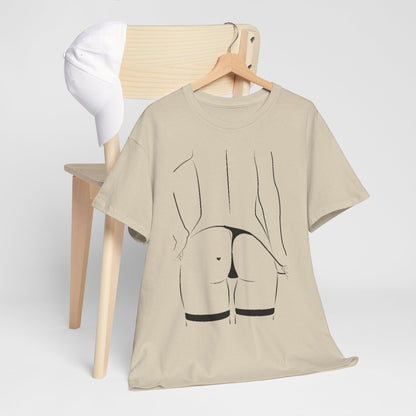 Casual unisex graphic T-shirt hung on a wooden chair alongside a white cap, showcasing a stylish black line drawing of a woman’s silhouette, perfect for contemporary wardrobes.