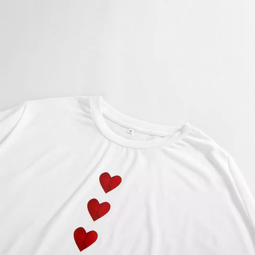 Elegant white plus size t-shirt featuring a unique heart print design, perfect for stylish street fashion.