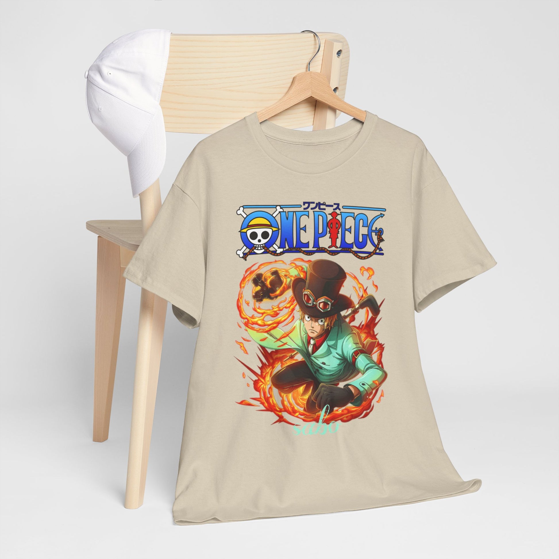 Stylish men's t-shirt adorned with an action-packed illustration of Sabo from One Piece, artistically displayed alongside a white cap, creating a chic ensemble.