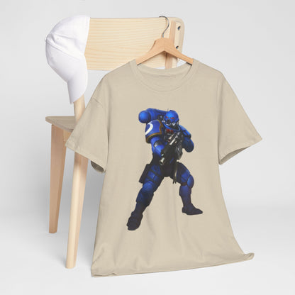 Trendy beige t-shirt draped elegantly on a wooden chair alongside a cap, displaying a vibrant blue armoured figure, ideal for casual wear that merges comfort and creativity.