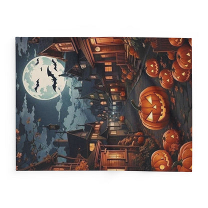 Decorative and Warm Halloween Spooky Arctic Fleece Blanket showcasing a charming Halloween scene with illuminated houses and carved pumpkins, ideal for sophisticated seasonal ambience.