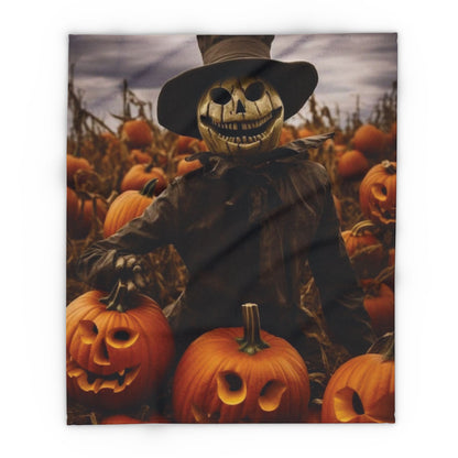 Elegant Decorative and Warm Halloween Spooky Arctic Fleece Blanket showcasing a scarecrow with a sinister smile amidst a pumpkin patch, ideal for seasonal décor.