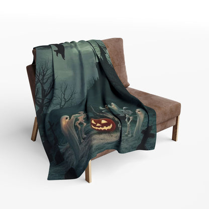 Luxurious decorative and warm Halloween spooky Arctic fleece blanket draped over a stylish armchair, featuring enchanting ghost and skeleton designs with a glowing jack-o'-lantern, perfect for adding seasonal charm to your home.