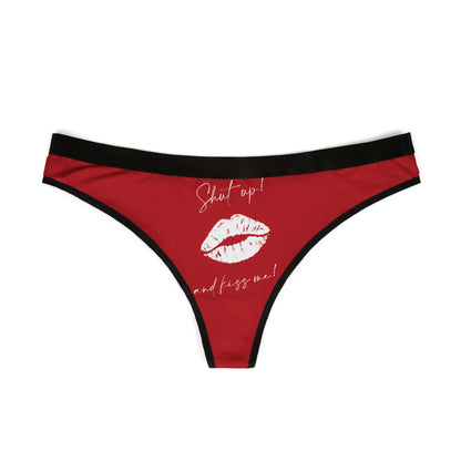 Front view of a luxurious women's thong in red, adorned with the cheeky phrase 'Shut Up and Kiss Me!' and a striking lip graphic.