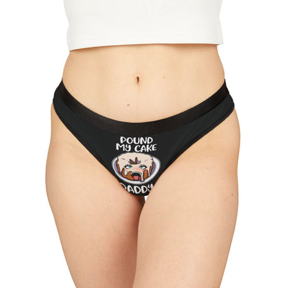 Luxurious black women's thong featuring a playful and humorous graphic design with the text 'POUND MY CAKE DADDY' and an anthropomorphic frosted cake illustration, perfect for Valentine's Day or cheeky celebrations.