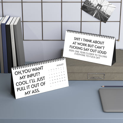 2025 Humorous Desktop Calendar for Work with Cheeky Quotes displayed on a modern desk, featuring humorous quotes like 'OH, YOU WANT MY INPUT? COOL. I’LL JUST PULL IT OUT OF MY ASS,' adding character to any workspace.