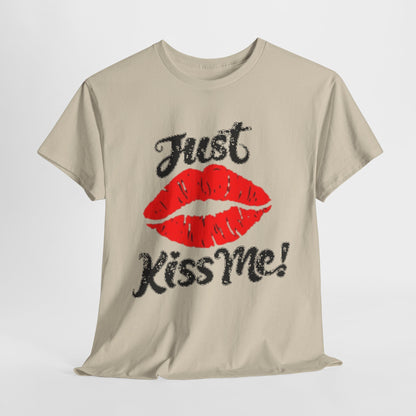 Luxurious unisex graphic t-shirt featuring bold red lips and the playful phrase "Just Kiss Me!" on a soft, neutral background, perfect for stylish casual wear.