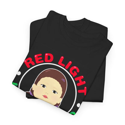 Stylish folded Squid Game unisex graphic T-shirt showcasing the playful 'RED LIGHT GREEN LIGHT' design, detailed with a vibrant character illustration, offering a unique blend of humour and high-end fashion.