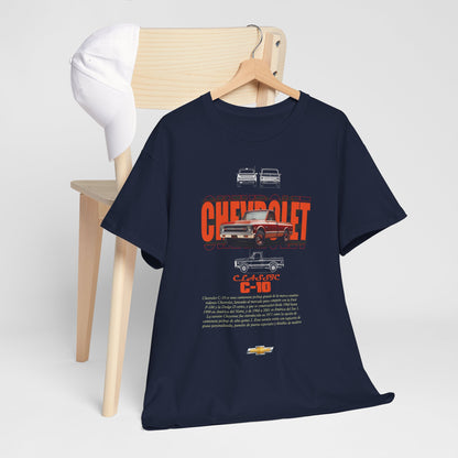 Classic Chevrolet C-10 t-shirt displayed on a wooden chair with a cap, featuring a sophisticated automotive graphic and luxurious cotton fabric for comfort and style.