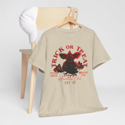Stylishly displayed graphic t-shirt with imposing Demogorgon artwork and 'Trick or Treat' lettering, designed for both men and women who appreciate unique fashion.
