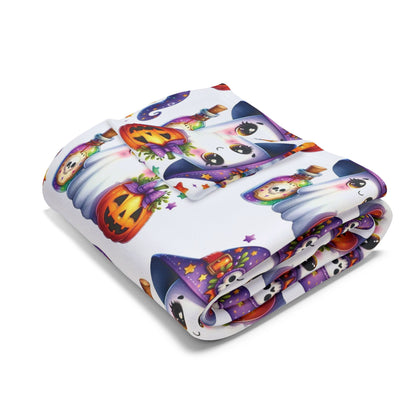 Decorative and Warm Halloween Cute Arctic Fleece Blanket folded showcasing whimsical ghost and pumpkin designs, perfect for adding seasonal charm to your home.
