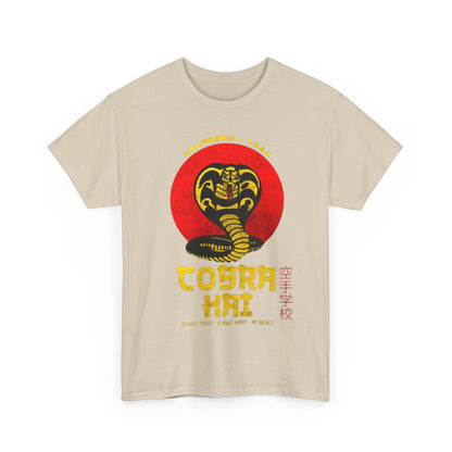 Elegant beige Cobra Kai graphic tee showcasing the iconic cobra logo against a vibrant red backdrop. Designed for unisex wear, this shirt combines fashion and nostalgia for avid fans.