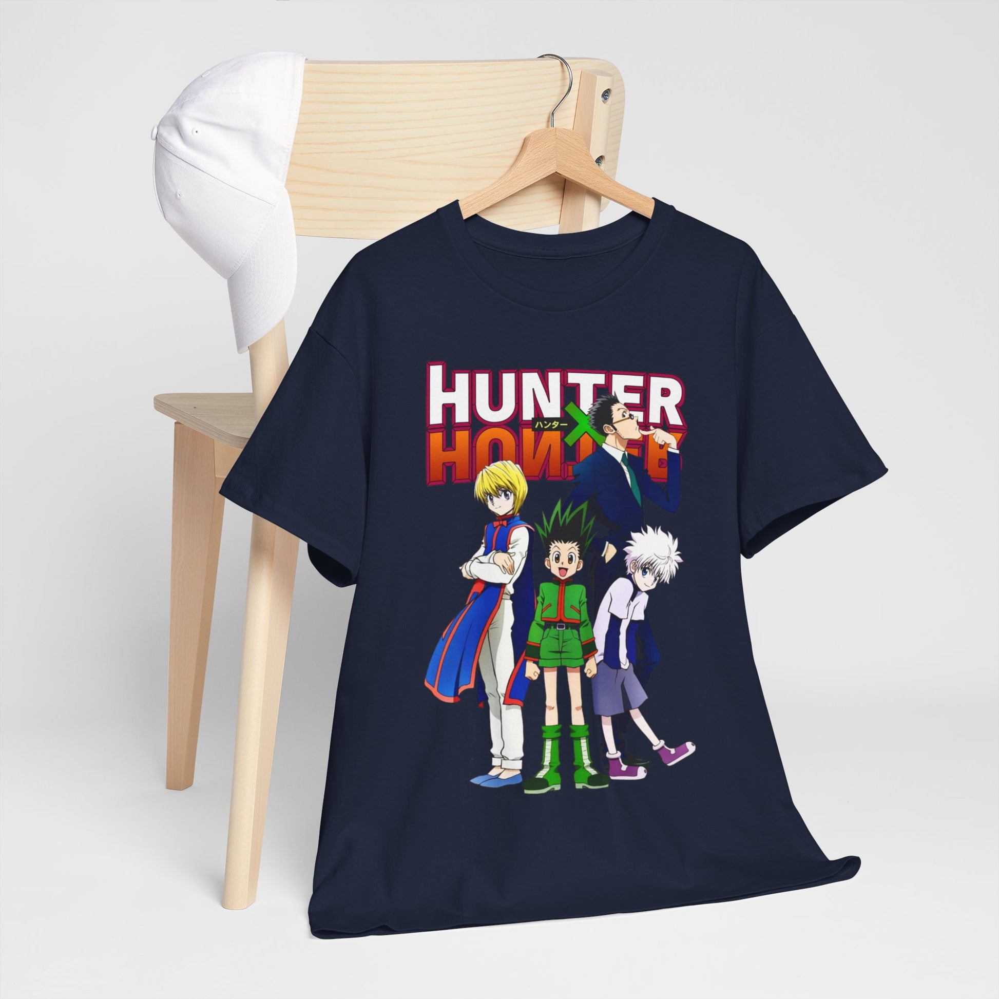 Sophisticated Hunter x Hunter T-shirt arranged on a wooden chair beside a cap, highlighting the artistic design and high-end appeal for anime enthusiasts.