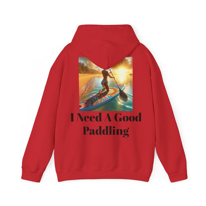 Fantasy Paddleboarding Unisex Hooded Sweatshirt in red, showcasing a bold graphic of a woman paddling at sunset with the phrase 'I Need A Good Paddling', designed for comfort and style.