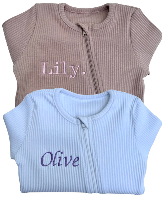 Luxury unisex white zip sleepsuit for babies aged 0-3 years by DreamBuy, crafted from soft ribbed cotton for ultimate comfort.