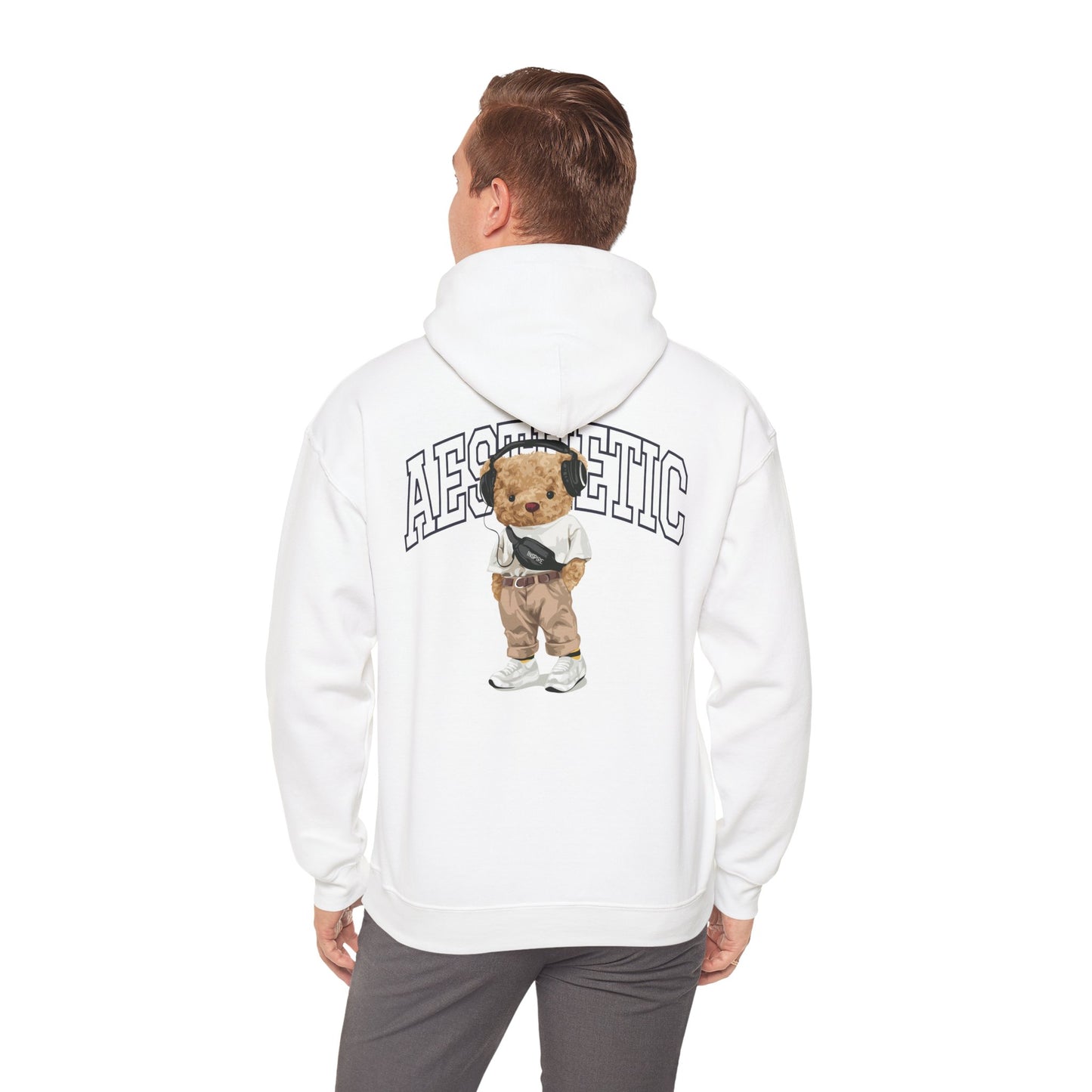 Chic male model showcasing a white hoodie featuring a playful teddy bear graphic, embodying a trendy aesthetic lifestyle.
