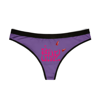 Elegant view of Bad Girl thong, showcasing the striking purple fabric adorned with daring red devil horns and the phrase 'Bad Girl' in alluring pink.