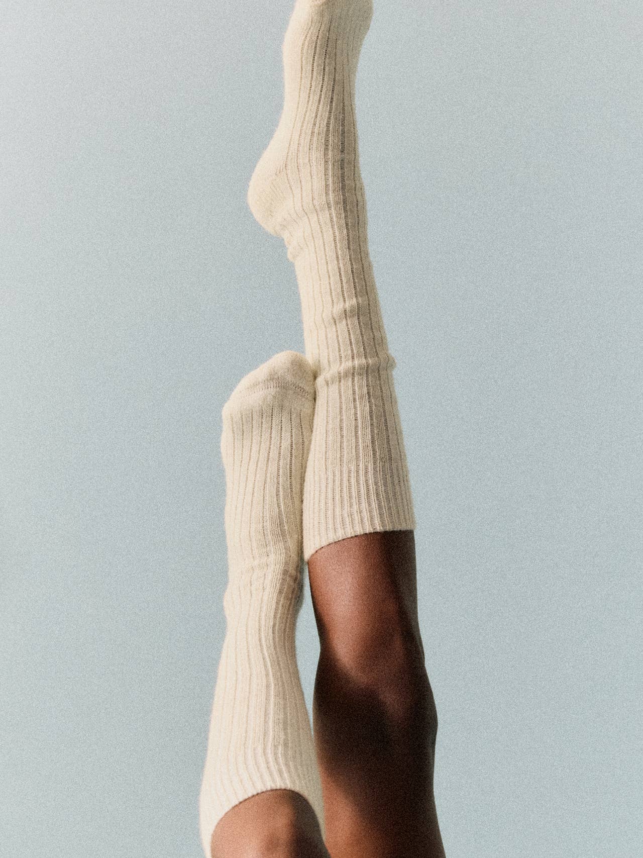 Luxurious knee high wool socks with cushioned sole, perfect for warmth and comfort in cold weather.