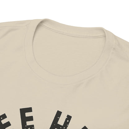 Close-up view of the neckline of a beige men's t-shirt, highlighting its soft fabric and stylish 'Free Hugs' print.