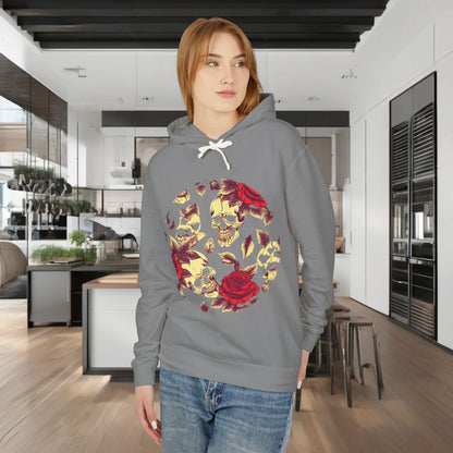 Model wearing the grey Unisex Lightweight Hooded Sweatshirt with a striking skull and roses print, set in a modern kitchen environment.