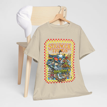 Luxurious beige graphic tee featuring vibrant 'Stranger Things' artwork, harmoniously draped over a chair alongside a stylish white cap, enhancing its urban chic appeal.