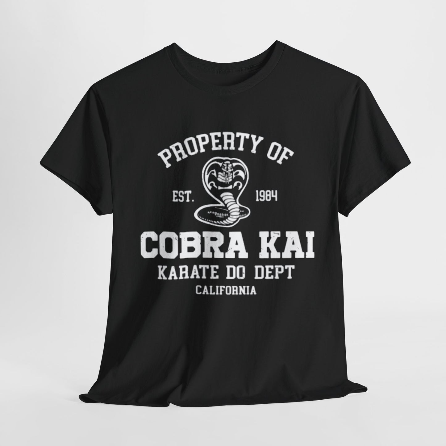 Luxurious black graphic T-shirt featuring the iconic Cobra Kai logo, with bold white text reading 'Property of Cobra Kai Karate Do Dept California', est. 1984, embodying a stylish homage to martial arts nostalgia.