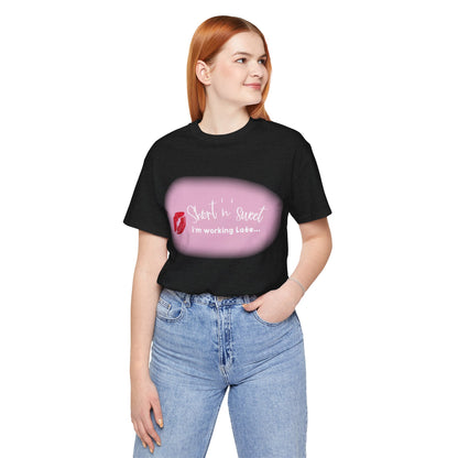 Sabrina Carpenter Inspired Unisex Short Sleeve Tee with Vibrant Lipstick Print, displayed on a female model in a chic outfit, highlighting the statement print against a stylish black background.