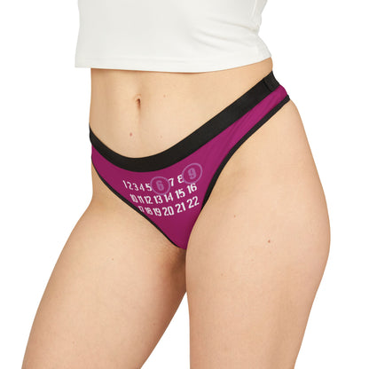 Elegant woman wearing a vibrant and playful 69 thong, featuring bold stenciled numbers against a rich pinkish-purple background, designed for comfort and confidence.