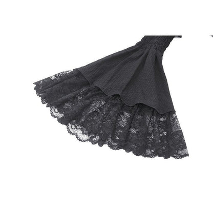 Stylish model wearing the Dark In Love Arya Gothic Lace Doll Dress, highlighting the whimsical asymmetrical ruffled skirt and sophisticated black hue.