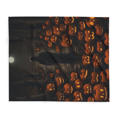 Artistic view of the Decorative and Warm Halloween Spooky Arctic Fleece Blanket showcasing a spooky scene with a mysterious figure amidst a backdrop of illuminated jack-o'-lanterns.
