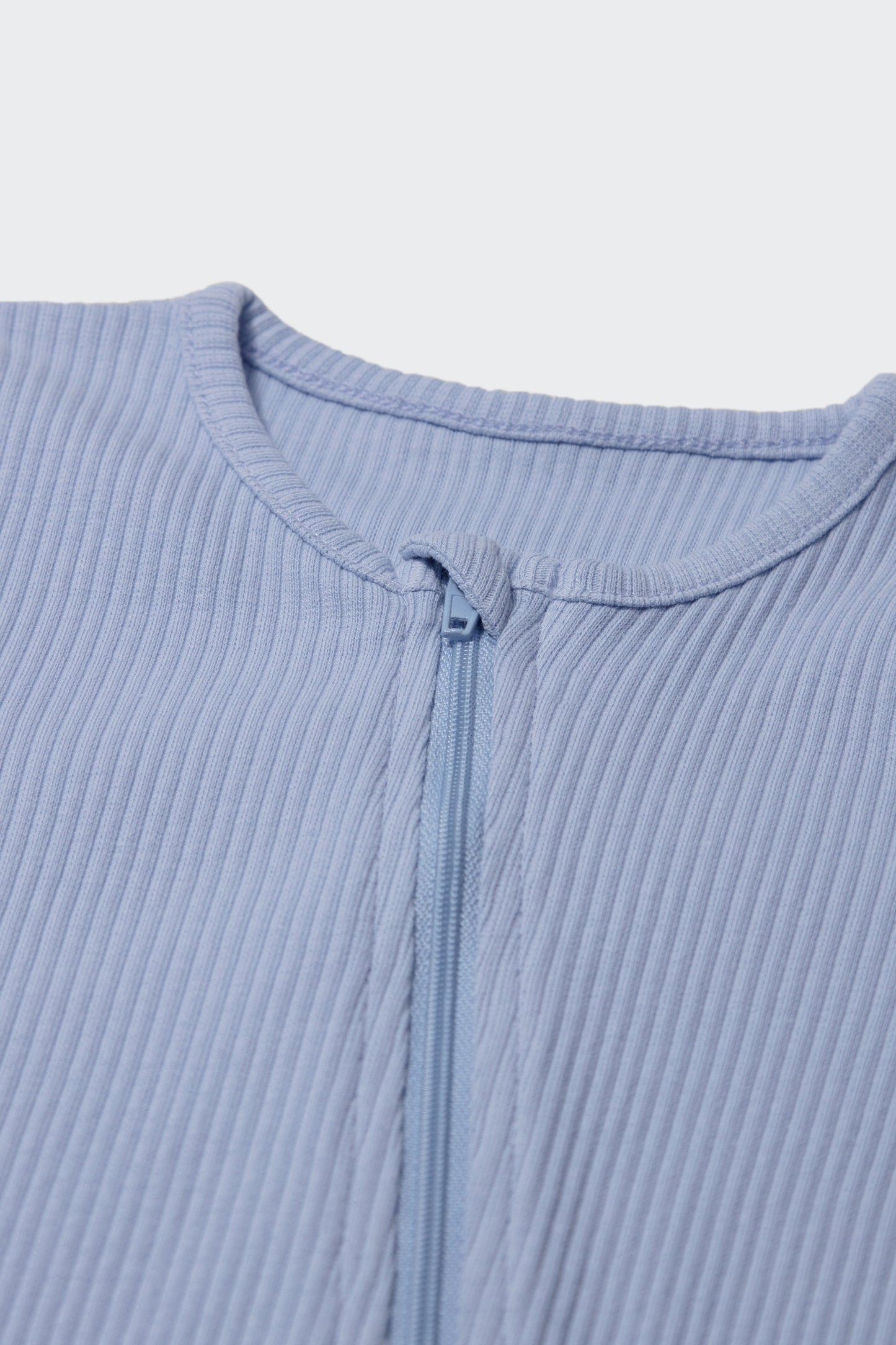 DreamBuy's Powder Blue Zip Sleepsuit displayed on a cute baby, exemplifying the chic and comfortable design perfect for new arrivals.