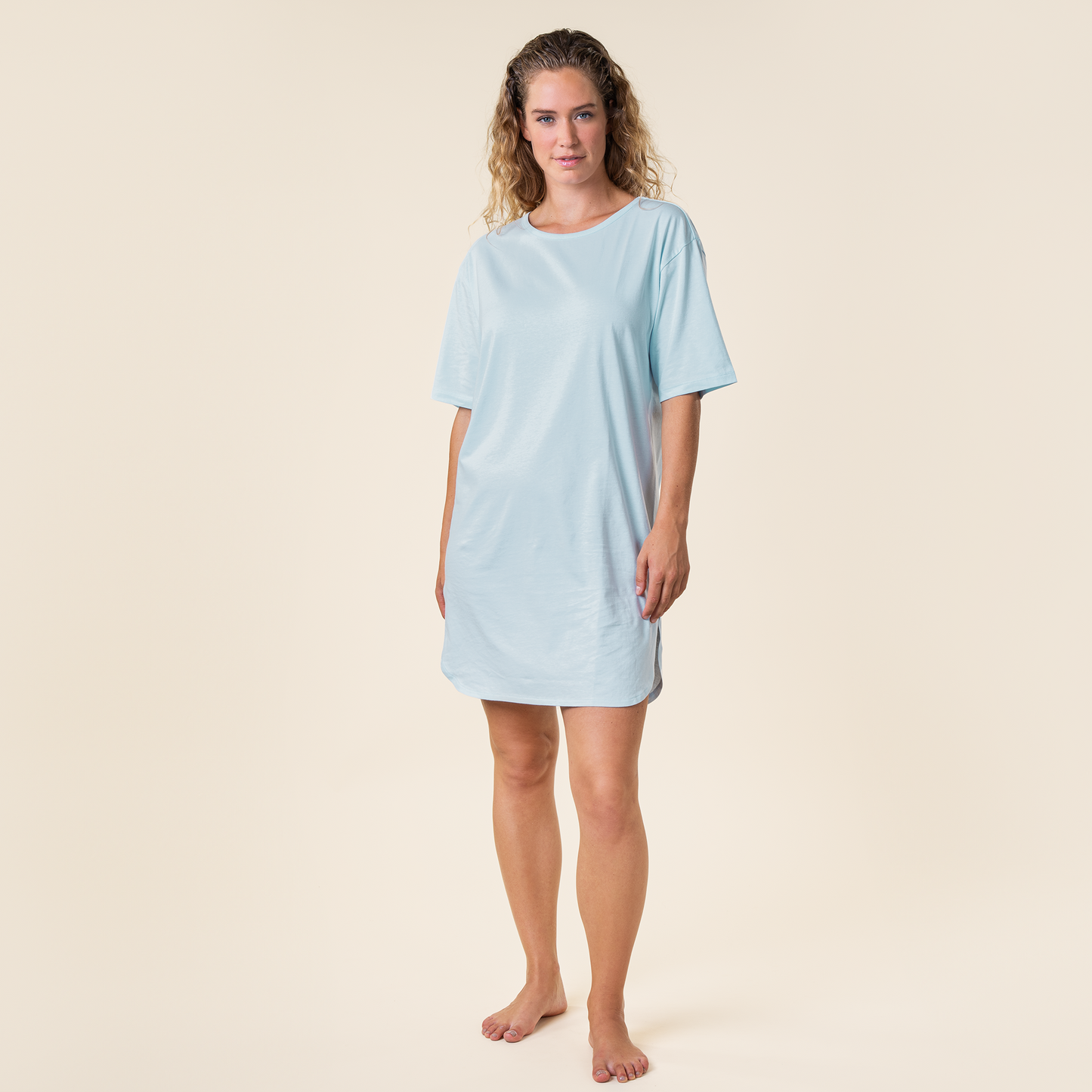 Luxurious mid-length night shirt for women, crafted from soft organic cotton, offering ultimate comfort and elegance for a restful night's sleep.