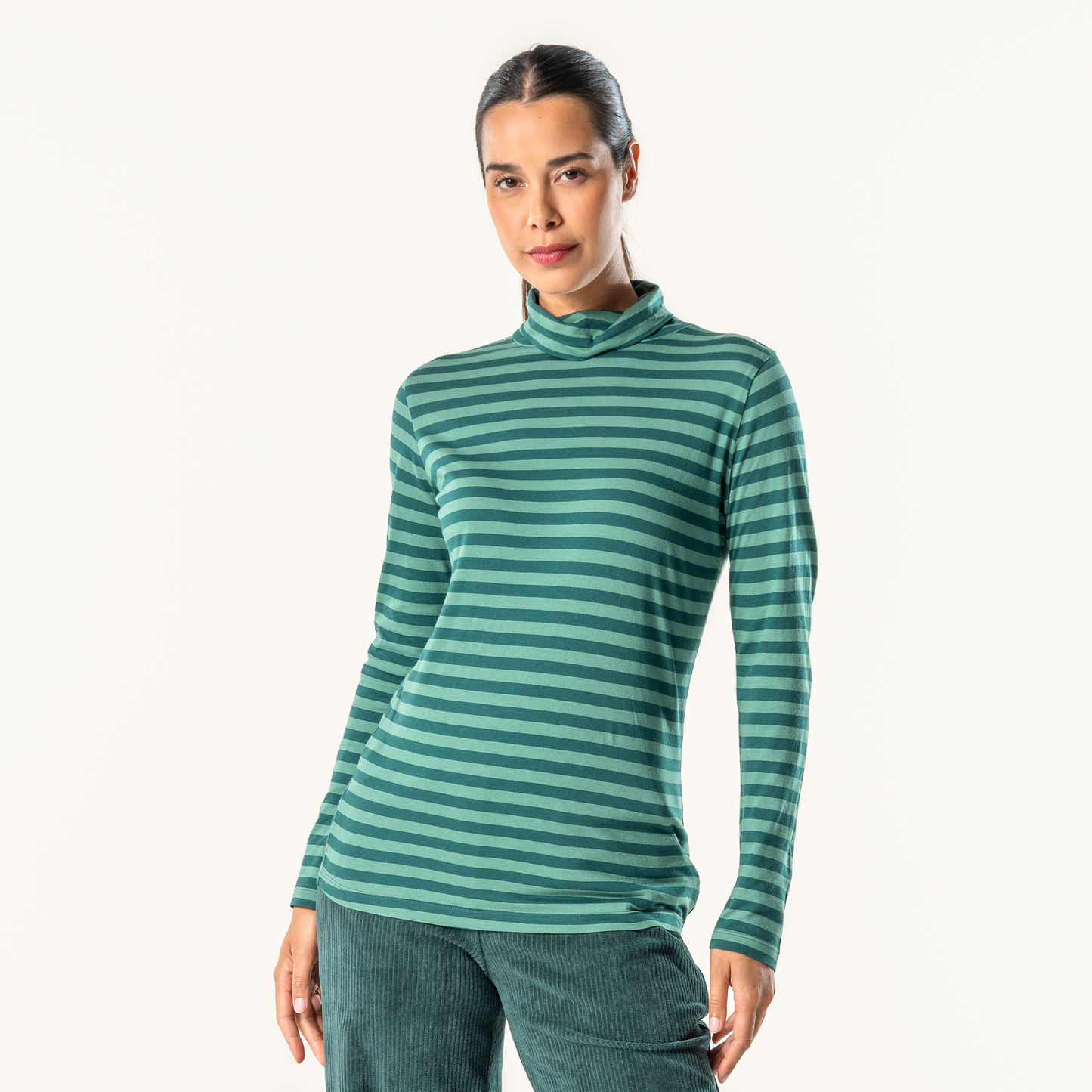 Luxury organic cotton turtleneck t-shirt for women, showcasing a stylish long-sleeve design in an elegant setting.