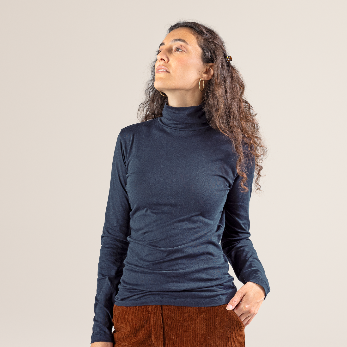 Luxury organic cotton women's turtleneck t-shirt, stylish long-sleeved top showcasing premium fabric and elegant design.