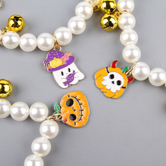 Close-up view of the exquisite Pet Pearl Necklace Decoration Halloween Cat Collar, showcasing detailed charms including a ghost, pumpkin, and skull, accented with elegant pearls and gold bells.