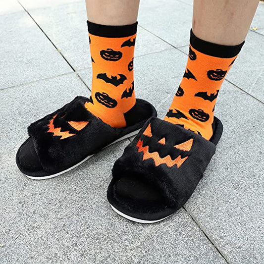 Halloween Shoes Winter Cute Warm Home Slippers for women featuring playful black design with pumpkin motifs, complemented by vibrant orange socks with bat patterns, ideal for festive indoor wear.