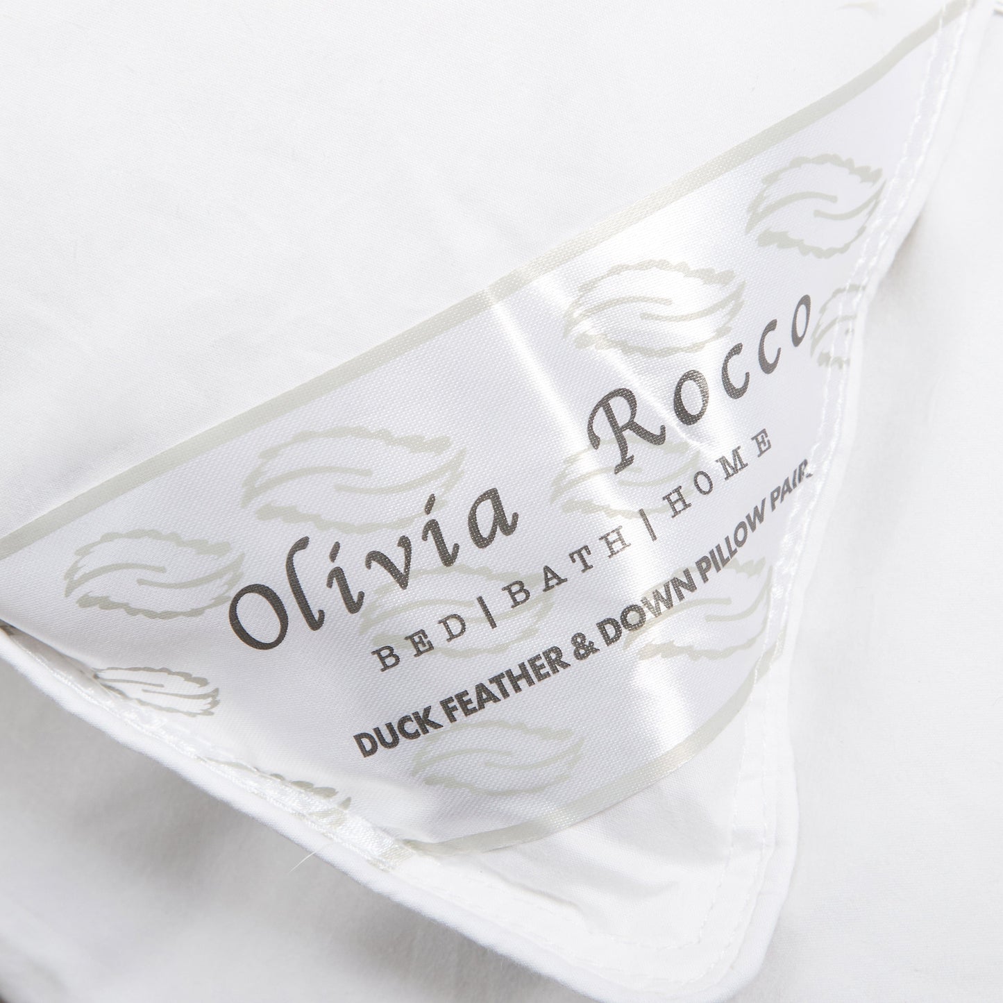 Stylish arrangement of OLIVIA ROCCO's luxury duck feather & down pillows in a serene bedroom setting, enhancing decor while providing ultimate comfort.