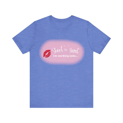 Sabrina Carpenter Inspired Unisex Short Sleeve Tee in sophisticated periwinkle, presenting a bold lipstick graphic with the phrase 'Short 'n' sweet, I'm working Late...' perfect for expressive style.