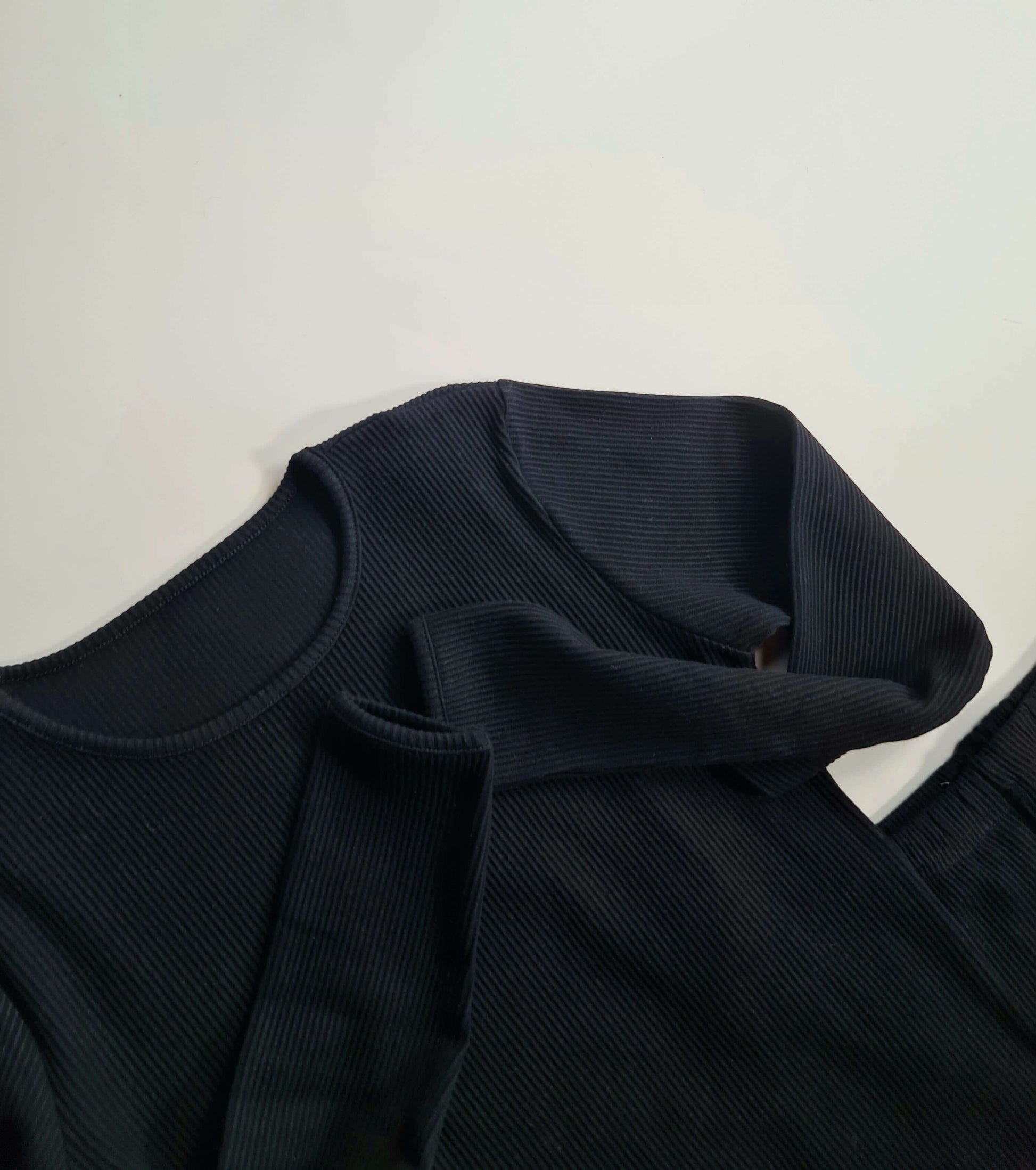 Elegant black matching family pyjamas designed by DreamBuy, featuring soft ribbed fabric suitable for all ages from 3 months to XXL, perfect for stylish comfort during family gatherings.